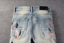 Load image into Gallery viewer, Amiri black and red paint stroke denim
